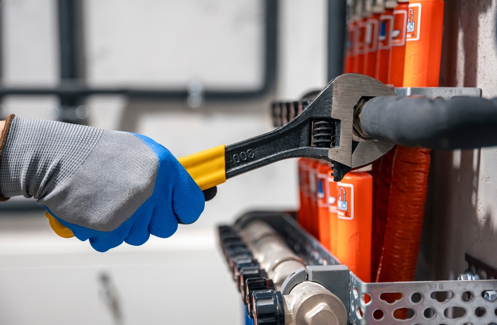 Male,Hands,With,A,Wrench,Turning,Off,Valves.